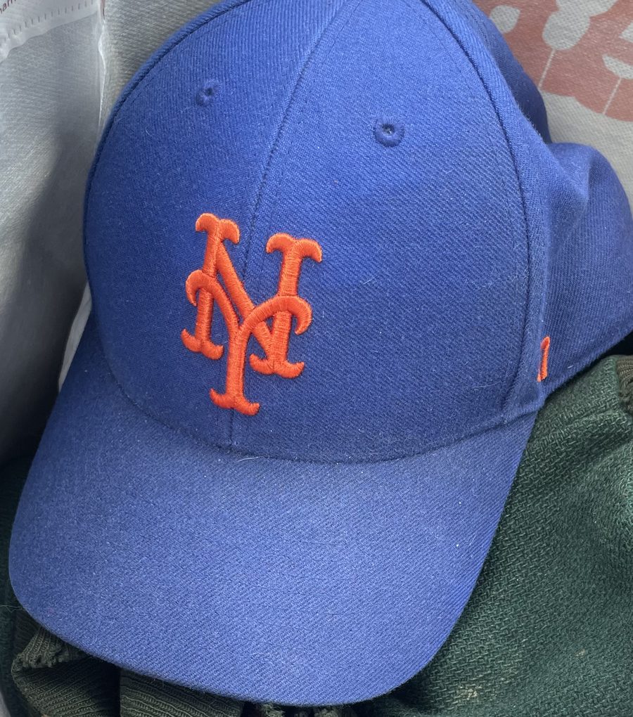A well-worn blue New York Mets baseball cap.